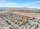 A high angle view of a residential neighborhood with desert landscaping and mountain views in the distance at 9074 Iron Cactus Ave, Las Vegas, NV 89148