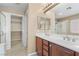 Bathroom featuring a double sink vanity, ample cabinet space, and a walk-in closet at 9074 Iron Cactus Ave, Las Vegas, NV 89148