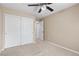 Bedroom with carpet, neutral paint, closet, and ceiling fan at 9074 Iron Cactus Ave, Las Vegas, NV 89148