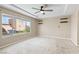 Bedroom with a large window, neutral carpet, and dark ceiling fan at 9074 Iron Cactus Ave, Las Vegas, NV 89148