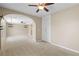 Carpeted bedroom with tray ceiling, archway and closet at 9074 Iron Cactus Ave, Las Vegas, NV 89148
