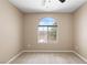 Simple bedroom features neutral paint, carpet, and a window at 9074 Iron Cactus Ave, Las Vegas, NV 89148