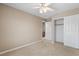 Neutral bedroom features ceiling fan, carpet, and a closet at 9074 Iron Cactus Ave, Las Vegas, NV 89148