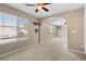 Neutral bedroom with carpet, ceiling fan, archway, and large windows at 9074 Iron Cactus Ave, Las Vegas, NV 89148