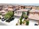 Home exterior showcasing a two-car garage, landscaped front yard, and a tiled roof at 9074 Iron Cactus Ave, Las Vegas, NV 89148