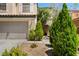 Inviting two-story house with a spacious driveway and well-manicured front yard at 9074 Iron Cactus Ave, Las Vegas, NV 89148
