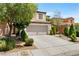 Inviting two-story house with a spacious driveway and well-manicured front yard at 9074 Iron Cactus Ave, Las Vegas, NV 89148