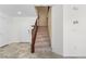 Bright foyer with tile flooring leading to carpeted stairs with a white front door at 9074 Iron Cactus Ave, Las Vegas, NV 89148