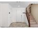Clean, bright foyer with tile floors, a staircase, and a white front door at 9074 Iron Cactus Ave, Las Vegas, NV 89148