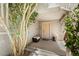 Inviting covered front porch with mature trees, neutral paint and plenty of space for seating at 9074 Iron Cactus Ave, Las Vegas, NV 89148