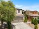 Charming two-story home featuring a neutral color palette, two car garage, and mature shade trees at 9074 Iron Cactus Ave, Las Vegas, NV 89148