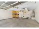 Spacious and organized garage featuring ample storage cabinets and clean epoxy flooring at 9074 Iron Cactus Ave, Las Vegas, NV 89148