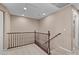 Carpeted second floor hallway with brown handrails and access to rooms at 9074 Iron Cactus Ave, Las Vegas, NV 89148