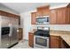 Modern kitchen with stainless steel appliances and granite countertops at 9074 Iron Cactus Ave, Las Vegas, NV 89148