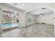 Open living area with tiled floors and sliding glass doors leading to the pool area at 9074 Iron Cactus Ave, Las Vegas, NV 89148