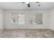Spacious living area with neutral tile flooring, ceiling fan, and backyard views at 9074 Iron Cactus Ave, Las Vegas, NV 89148