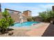A serene pool area, complete with lush greenery and a paved patio, perfect for relaxation and outdoor enjoyment at 9074 Iron Cactus Ave, Las Vegas, NV 89148
