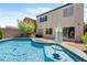 A serene backyard pool is the focal point, enhanced by mature trees and home access at 9074 Iron Cactus Ave, Las Vegas, NV 89148
