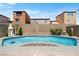 A sparkling pool, bordered by a stone wall and beautiful landscaping, provides a private backyard oasis at 9074 Iron Cactus Ave, Las Vegas, NV 89148