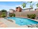 A beautiful pool with decorative rocks, complemented by lush greenery, offers a serene backyard escape at 9074 Iron Cactus Ave, Las Vegas, NV 89148