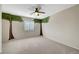 Cozy bedroom featuring neutral carpet, large windows, tree murals and a modern ceiling fan at 9542 Ridgeglen Ct, Las Vegas, NV 89148