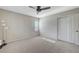 Neutral bedroom with carpet, ceiling fan and a double-door closet; perfect for an organized living space at 9542 Ridgeglen Ct, Las Vegas, NV 89148