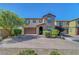 Charming two-story home featuring a desert landscape and a spacious driveway at 9542 Ridgeglen Ct, Las Vegas, NV 89148