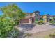Charming two-story home featuring a desert landscape and a spacious driveway at 9542 Ridgeglen Ct, Las Vegas, NV 89148