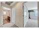 Hallway leading to a bedroom and a bathroom with luxury vinyl tile floors and natural light at 9542 Ridgeglen Ct, Las Vegas, NV 89148