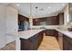 Beautiful kitchen with stainless steel appliances, an island, and dark wood cabinets at 9542 Ridgeglen Ct, Las Vegas, NV 89148