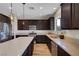 Modern kitchen features stainless steel appliances, dark wood cabinets, and a large center island at 9542 Ridgeglen Ct, Las Vegas, NV 89148