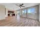 Spacious living room with lots of natural light and wood-look tile flooring and ceiling fan at 9542 Ridgeglen Ct, Las Vegas, NV 89148