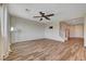 Bright living room with ceiling fan, wood-look floors, and modern decor at 9542 Ridgeglen Ct, Las Vegas, NV 89148