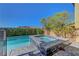 Inviting pool and spa area surrounded by lush landscaping and stylish pavers, ideal for outdoor relaxation at 9542 Ridgeglen Ct, Las Vegas, NV 89148