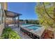 The outdoor space features a stone-trimmed spa, complemented by lush greenery at 9542 Ridgeglen Ct, Las Vegas, NV 89148