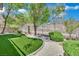View of backyard featuring artificial turf, desert landscaping and rock features at 96 Saint Johns Wood Ave, Henderson, NV 89002
