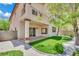 Charming home featuring a synthetic grass putting green, stone landscaping and a covered patio at 96 Saint Johns Wood Ave, Henderson, NV 89002