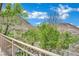 Balcony view showcasing mature landscaping, mountain views and wrought iron railing at 96 Saint Johns Wood Ave, Henderson, NV 89002