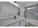 Bathroom featuring a tiled shower, tub, and double vanity with a large mirror at 96 Saint Johns Wood Ave, Henderson, NV 89002