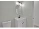 Stylish half-bathroom featuring modern vanity, sink, and fixtures, with a toilet to the left at 96 Saint Johns Wood Ave, Henderson, NV 89002