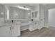 Bright bathroom with double sinks, a large mirror, and modern fixtures throughout at 96 Saint Johns Wood Ave, Henderson, NV 89002