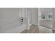 Modern bathroom featuring a bathtub, glass shower, and a view into the bedroom space at 96 Saint Johns Wood Ave, Henderson, NV 89002