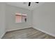 Bright bedroom featuring wood-look floors and a window offering ample natural light at 96 Saint Johns Wood Ave, Henderson, NV 89002