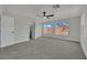 Bright bedroom featuring carpet, ceiling fan, and two windows offering ample natural light at 96 Saint Johns Wood Ave, Henderson, NV 89002