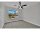 Serene bedroom with neutral walls, gray carpet, and large window at 96 Saint Johns Wood Ave, Henderson, NV 89002