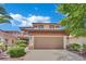 Exterior view of a two-story home showcasing the two-car garage and desert landscaping at 96 Saint Johns Wood Ave, Henderson, NV 89002