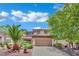 Front exterior view of a two-story home with a two-car garage and desert landscaping at 96 Saint Johns Wood Ave, Henderson, NV 89002