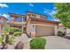 Exterior view of a two-story home showcasing the two-car garage, desert landscaping and a front entrance at 96 Saint Johns Wood Ave, Henderson, NV 89002