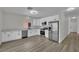 Bright kitchen featuring white cabinets, stainless steel appliances, and wood-style floors at 96 Saint Johns Wood Ave, Henderson, NV 89002