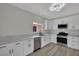 Modern kitchen features all-white cabinetry and stainless steel appliances at 96 Saint Johns Wood Ave, Henderson, NV 89002